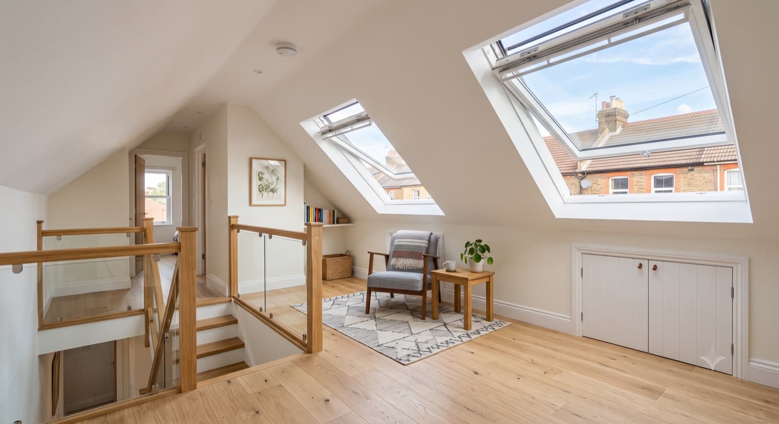 Loft Conversions in Solihull: a bright finished loft conversion with Velux roof windows, sloped ceilings and an engineered-wood floor